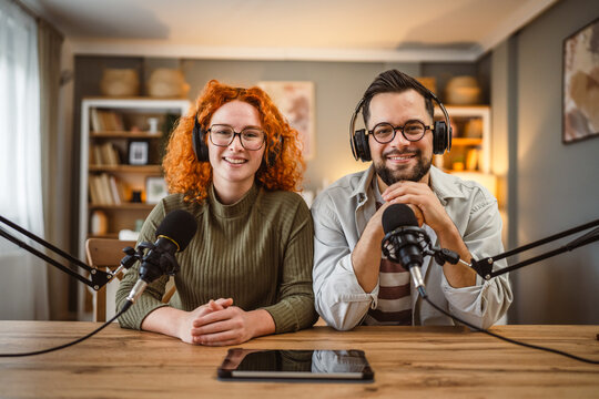 portrait of two radio hosts smile and enjoy while record podcast