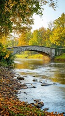 Obraz premium Tranquil Autumn Landscape with Stone Bridge Over Calm River