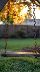 Wooden Swing Hanging in a Lush Green Backyard at Sunset Glow