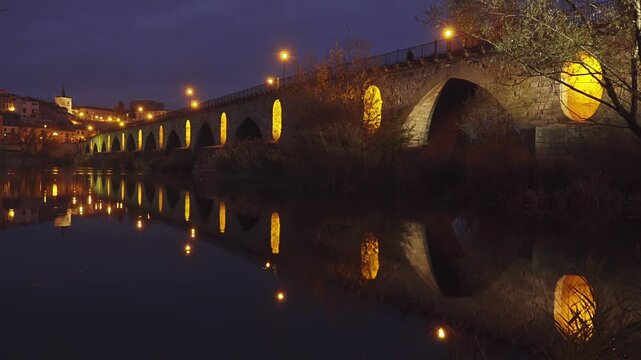 Illumination on Stone bridge on Duero river. Mengue avenue. Zamora Museum. Church of Santa Lucia. Zamora is a city in Castile and Leon, Spain. Evening time.