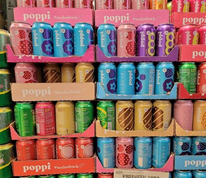 Poppi Prebiotic Soda 4g sugar - 12 Fl Oz 355ml cans in Key Food store in Queens, NY, USA: raspberry rose, strawberry, wild berry, lemon lime, root beer, classic cola. Photo by Artist Nadia Russ.