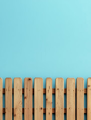 Fototapeta premium Wooden fence against a clear blue sky.