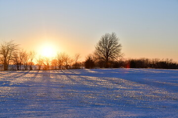 Sunset Over Snowy Field