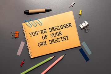Arrow on asphalt road written word you're designer of your own destiny