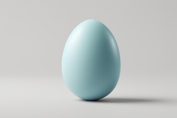 Fototapeta premium there is a blue egg that is sitting on a table