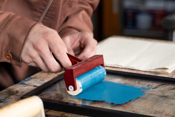 painting with a roll on a glass surface