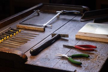 table with set of tools for metal engraving