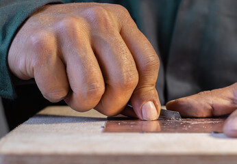 Close-up of blacksmith - artisan - craftman shaping metal