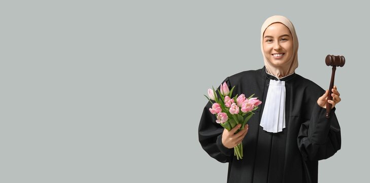 Muslim female judge holding tulips on grey background with space for text. Women's Day celebration - Powered by Adobe