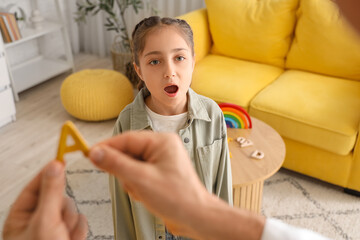 Little girl pronouncing letter A at speech therapist's office