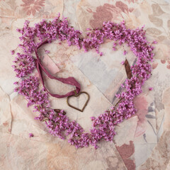 Red Bud Blossoms Surrounding a Hear-Shaped Locket on Ribbon © DiAnna