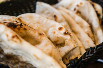 Roghni Naan is softer, thicker, and richer than plain naan, has a beautiful golden shine on it, and is covered with sesame seeds served warm.