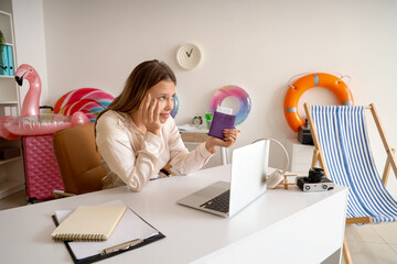 Thoughtful businesswoman with passport waiting for summer vacation in office
