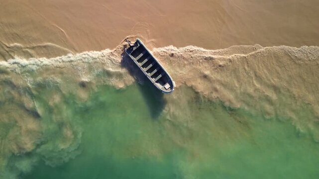 Aerial top view of a boat anchored in the Caribbean Sea along the coast of the Dominican Republic. The concept of adventure, tourism, the power of nature and travel