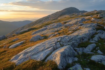 Obraz premium A rocky slope with detailed rock textures, illuminated by sunset light, creating vivid contrasts between shadows and warm tones