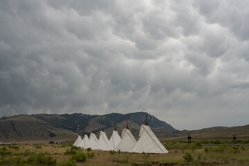 Seven Teepees Stand Tall Below Dramatic Sorm Clouds In Gardiner