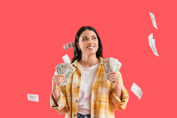 Beautiful woman with dollar banknotes on red background