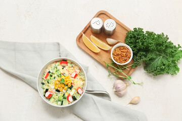 Bowl of salad with crab sticks, corn and cucumber on white grunge background © Pixel-Shot
