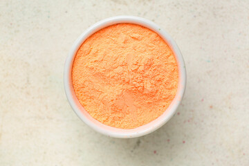 Bowl with color powder pigment on light background