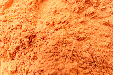 Texture of bright powder pigment as background, closeup