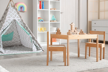 Interior of children's room with play tent, table and toys