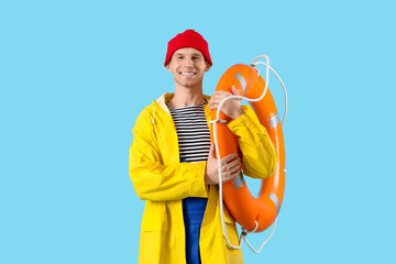 Male sailor with rescue ring on blue background
