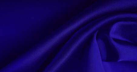 Deep blue silk fabric with smooth folds, showcasing a luxurious and elegant texture perfect for high-end fashion and interior design projects.