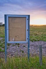 Old wooden notice board in a field