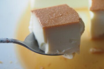  Caramel custard pudding on a plate on table 