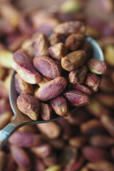 A closeup view showcasing Raw Pistachio Nuts elegantly arranged in a Spoon