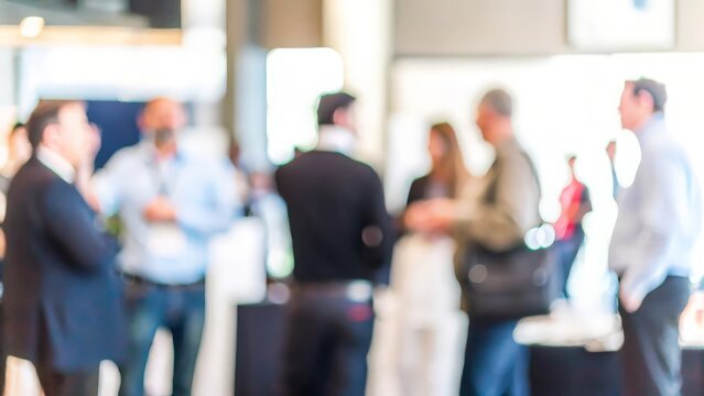 Annual Business Meetup Blur – A blurred scene of an annual business meetup with colleagues interacting.
