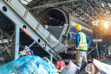An Engineer in protective checking automated systems, recycling industry, waste separation plant.