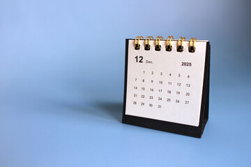 Monthly calendar template for the new year 2025 desk calendar,isolated on Blue background.