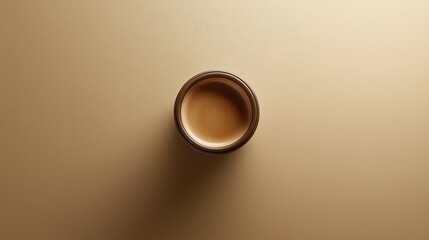 Overhead View of Simple Ceramic Cup on Warm Beige Surface