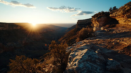 Obraz premium The sun is setting over a canyon, casting a warm glow over the landscape. generated using AI