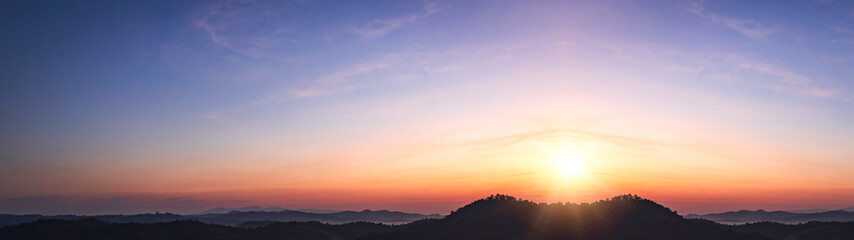 Sunrise over the mountains. Panoramic view of the mountain range.