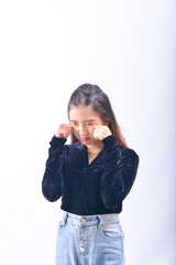 A young Asian Woman in a Black Velvet Top and Denim Jeans making expressive gestures Isolated on white background