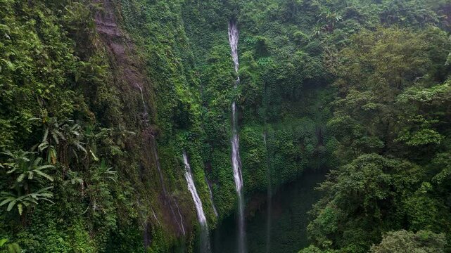 Drone view Madakaripura Waterfall - spectacular waterfall lies hidden at the end of a deep valley in the foothills of the Tengger mountain range, East Java, Surabaya, Indonesia