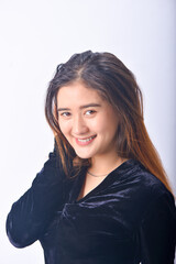 A young Asian Woman in a Black Velvet Top and Denim Jeans making expressive gestures Isolated on white background