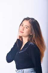 A young Asian Woman in a Black Velvet Top and Denim Jeans making expressive gestures Isolated on white background