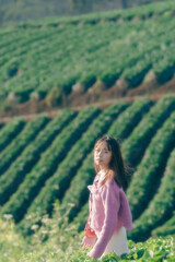 Beauty Girl Outdoors enjoying nature on the Spring Field, Sun Light.