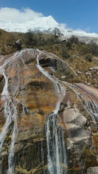 Aerial of Waterfall near Lagoon 513 with Snow-Capped Mountains, Vertical Ascent