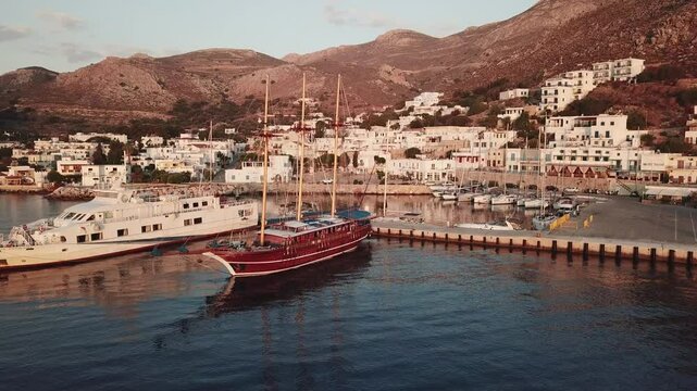 Greece,Tilos Island,Aerial view of Harbour and village,half circle pan,medium shot on sunny day
