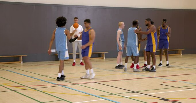 Basketball players in gym shaking hands, building team spirit and camaraderie