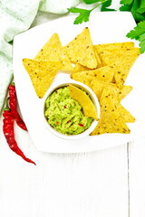 Guacamole in bowl on light board top