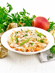 Salad of Jerusalem artichoke and apple in plate on table