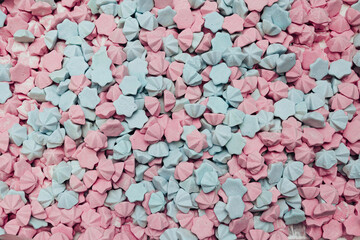 Industrial production of sweeties. Light pink and mint marshmallows background, sugar confetti