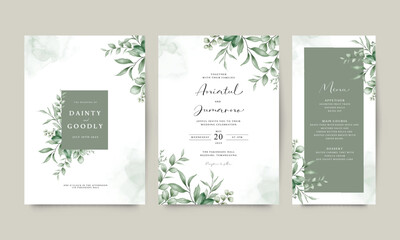 Wedding invitation card arranged with green leaves