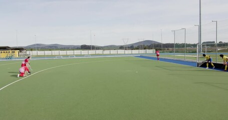 Female hockey players preparing for penalty corner on outdoor field - Powered by Adobe