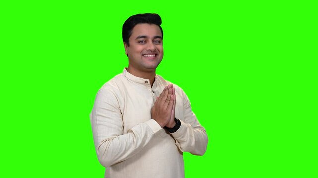 A young Indian man folding hands and greeting everyone. Welcome and Namaskar- an Indian tradition.